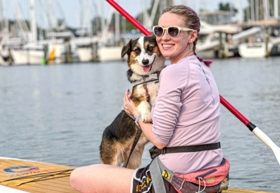 woman with dog on paddleboard